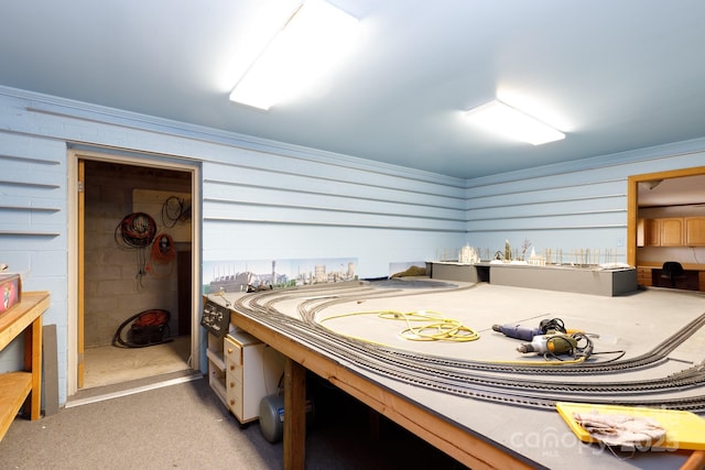 bedroom with concrete block wall and crown molding