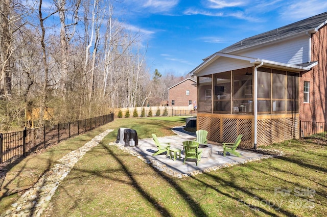 view of yard featuring a sunroom, a fenced backyard, and a patio