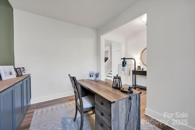 office space with baseboards and wood finished floors