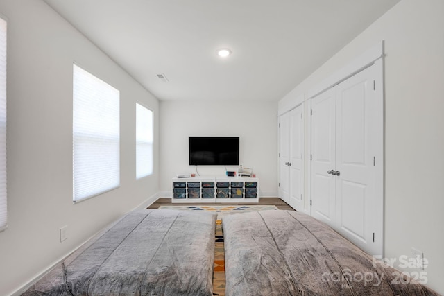 bedroom featuring wood finished floors and baseboards