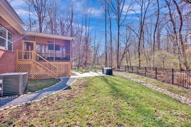 view of yard featuring a fenced backyard, cooling unit, a sunroom, stairway, and a patio area