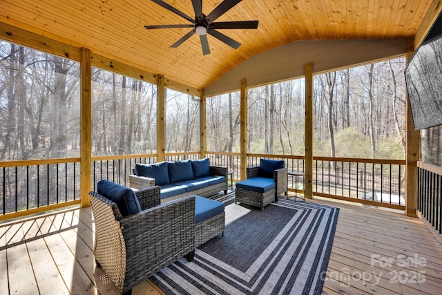 sunroom / solarium featuring lofted ceiling, wooden ceiling, and ceiling fan