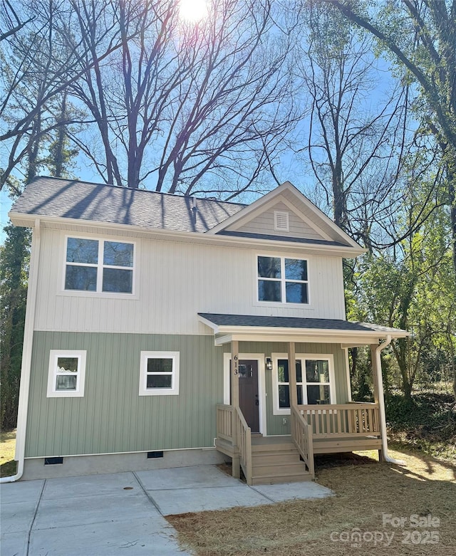 view of front facade featuring a shingled roof, crawl space, and covered porch