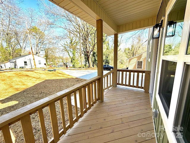 wooden terrace with a residential view and covered porch