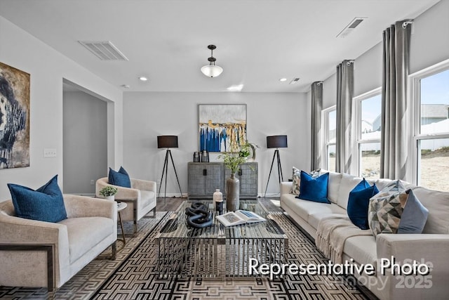 living area with baseboards, visible vents, dark wood-style flooring, and recessed lighting