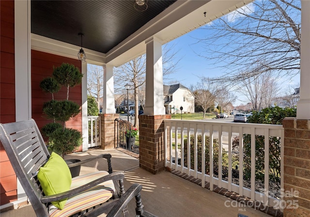 view of patio featuring a porch and a residential view