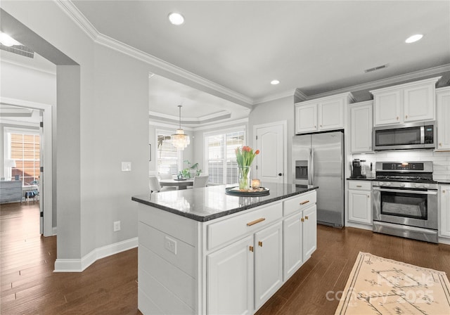 kitchen featuring visible vents, ornamental molding, stainless steel appliances, white cabinets, and dark wood-style flooring