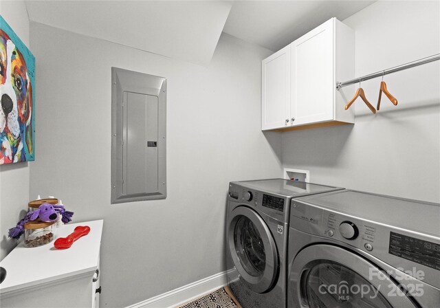 laundry area featuring electric panel, baseboards, cabinet space, and washer and clothes dryer