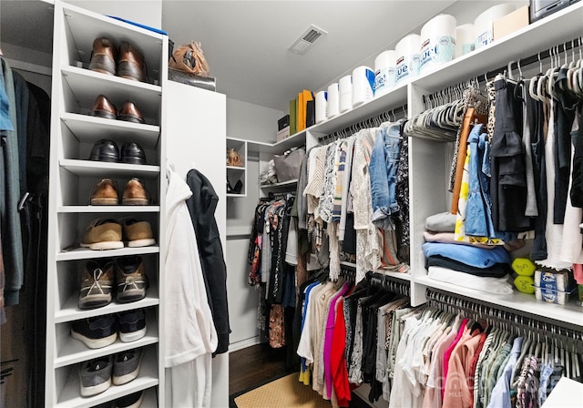 walk in closet with wood finished floors and visible vents