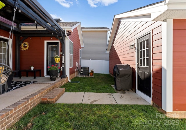 view of yard featuring a patio area, central air condition unit, and fence