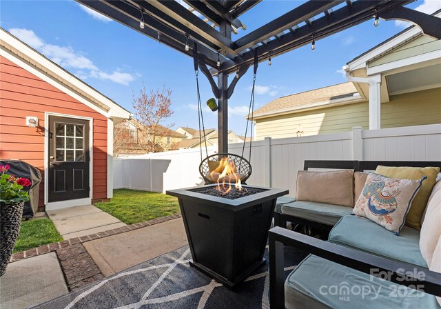 view of patio featuring an outdoor living space with a fire pit, area for grilling, and fence