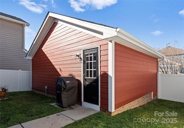 view of outbuilding with an outbuilding and fence