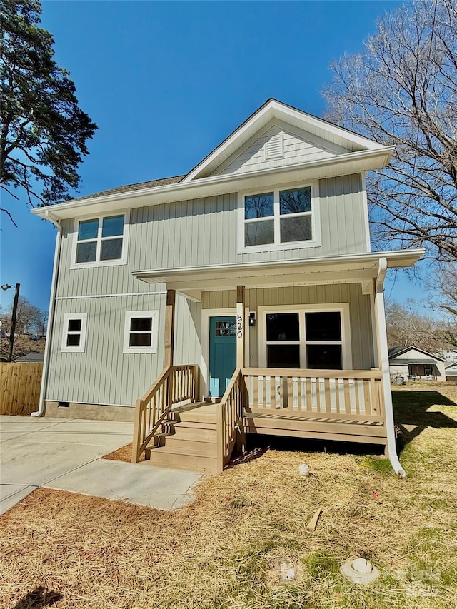 view of front facade with board and batten siding and crawl space