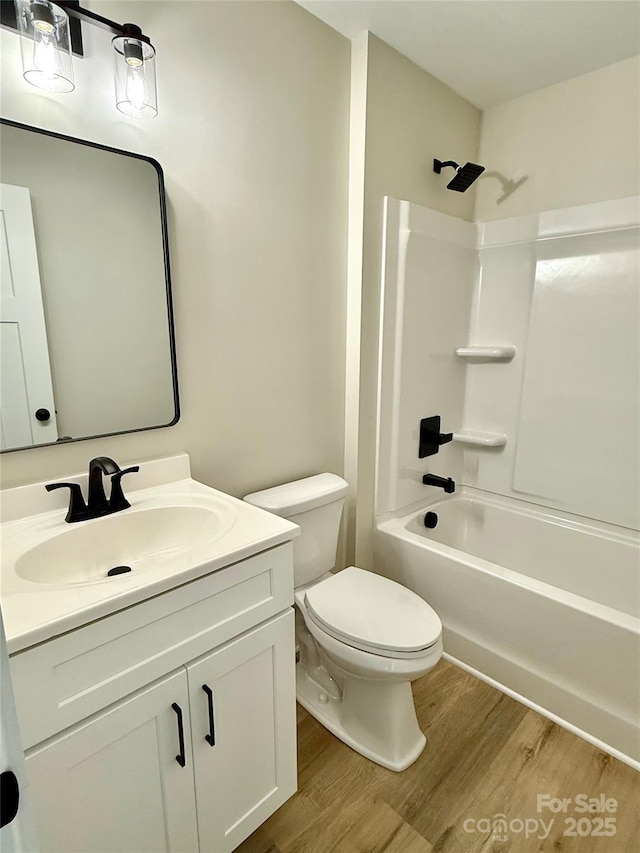 full bathroom with shower / bath combination, vanity, toilet, and wood finished floors