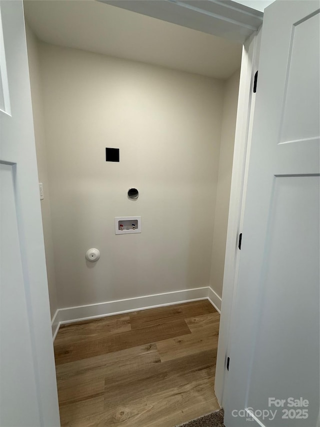 washroom with hookup for a gas dryer, laundry area, washer hookup, wood finished floors, and baseboards