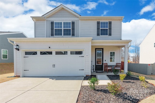 traditional home featuring driveway, covered porch, a garage, and fence