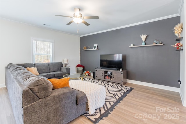 living area with baseboards, visible vents, crown molding, and light wood finished floors