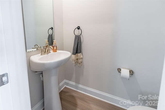 bathroom featuring wood finished floors and baseboards