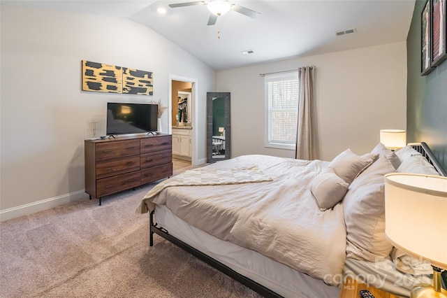 carpeted bedroom with ensuite bathroom, a ceiling fan, visible vents, vaulted ceiling, and baseboards