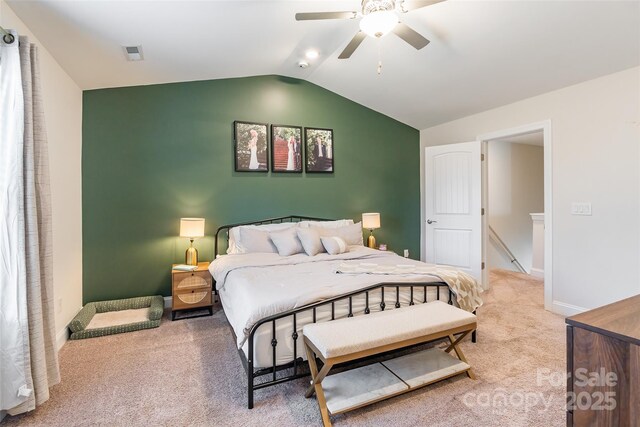 bedroom featuring light carpet, a ceiling fan, visible vents, vaulted ceiling, and baseboards