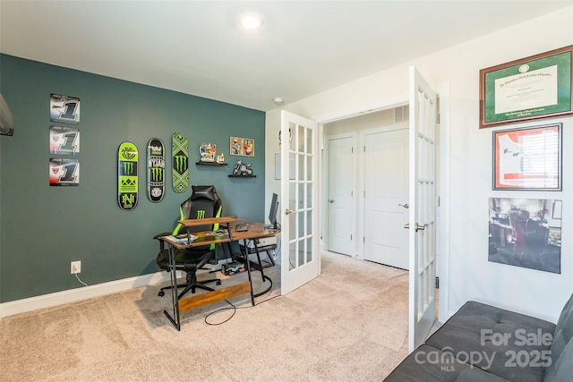 office area featuring light carpet, baseboards, and french doors