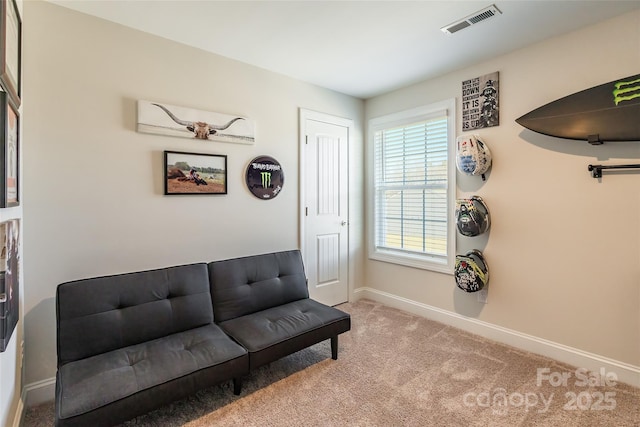 living area featuring light carpet, visible vents, and baseboards