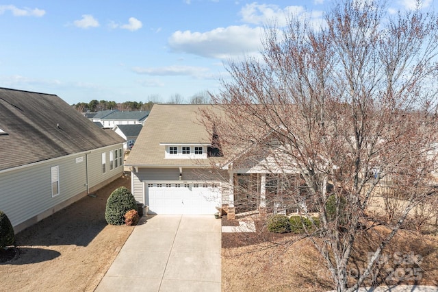 view of front of property featuring a garage and concrete driveway