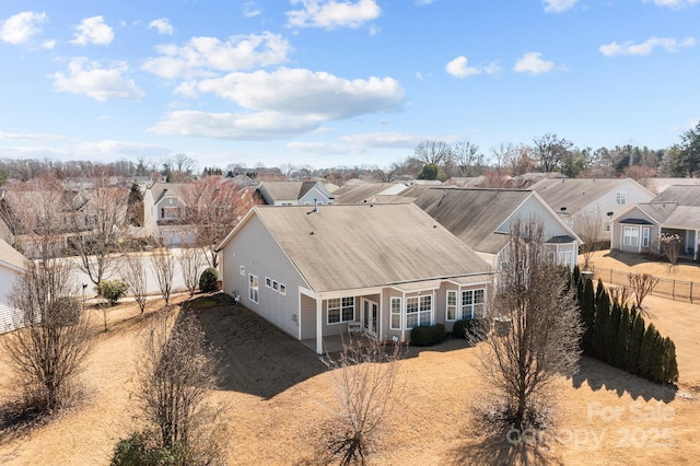 birds eye view of property with a residential view