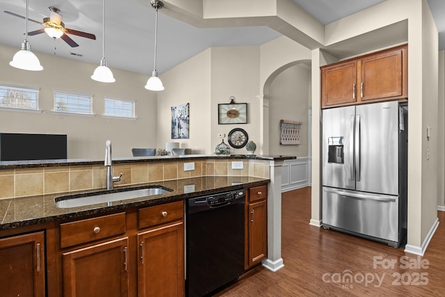 kitchen featuring dark wood-type flooring, a sink, stainless steel fridge with ice dispenser, brown cabinets, and dishwasher