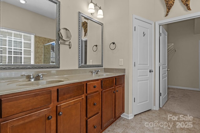 full bathroom with tile patterned flooring, a sink, a shower stall, and double vanity