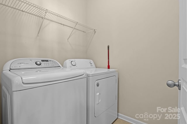 laundry room featuring laundry area, baseboards, and separate washer and dryer