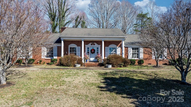 greek revival inspired property with crawl space, a shingled roof, a front yard, and brick siding