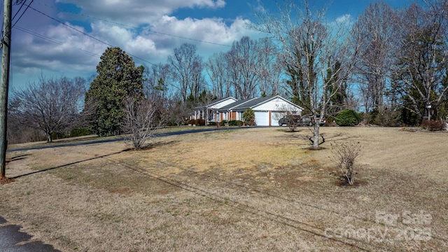 view of front facade with a garage and a front lawn