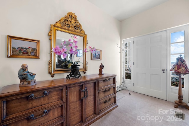 entryway with a baseboard radiator and light colored carpet