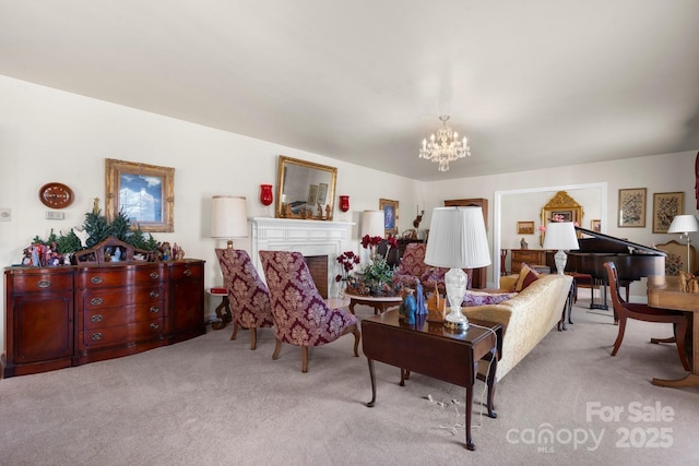 living room with carpet, a fireplace, and an inviting chandelier