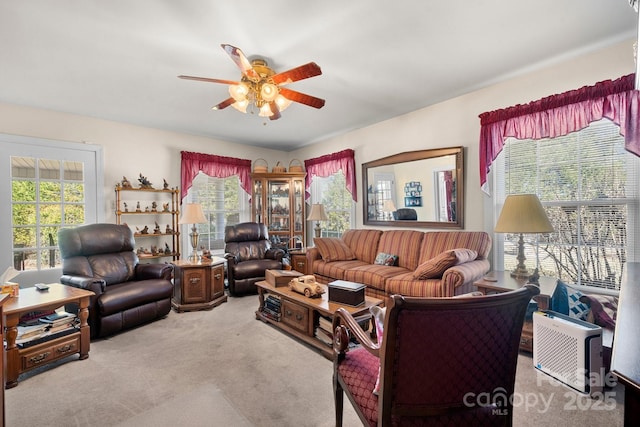 living area with carpet floors and ceiling fan