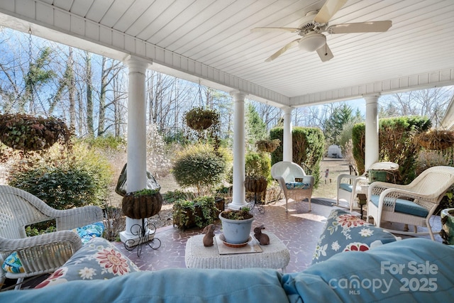 sunroom featuring ceiling fan