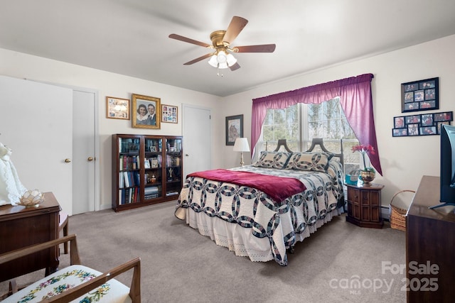 bedroom with a ceiling fan and carpet