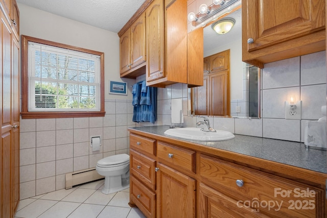 bathroom featuring toilet, a baseboard radiator, tile patterned floors, a textured ceiling, and vanity