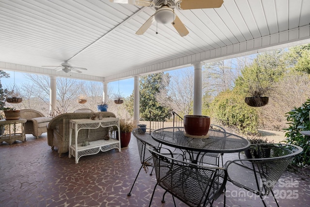 sunroom featuring a healthy amount of sunlight and ceiling fan