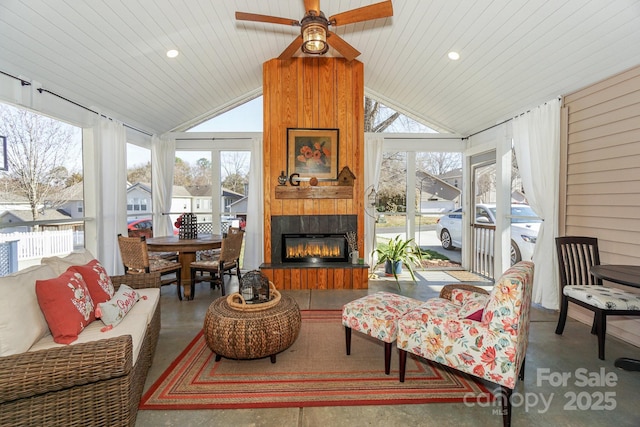 sunroom featuring wooden ceiling, a fireplace, vaulted ceiling, and a wealth of natural light