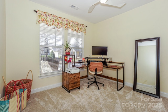 carpeted office with baseboards, visible vents, and a ceiling fan