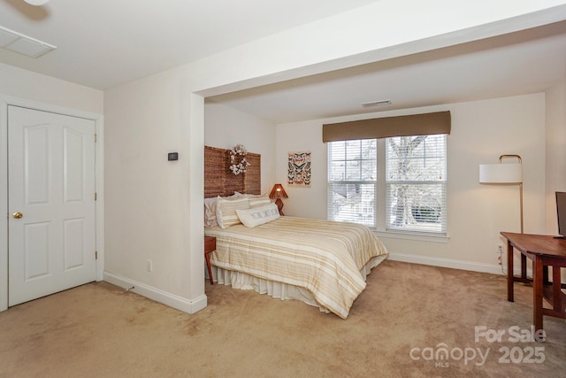 carpeted bedroom featuring visible vents and baseboards