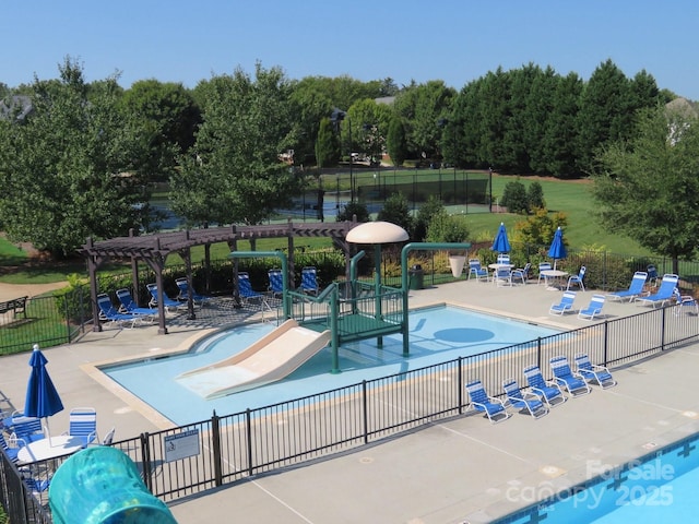 pool with fence, a patio, and a pergola