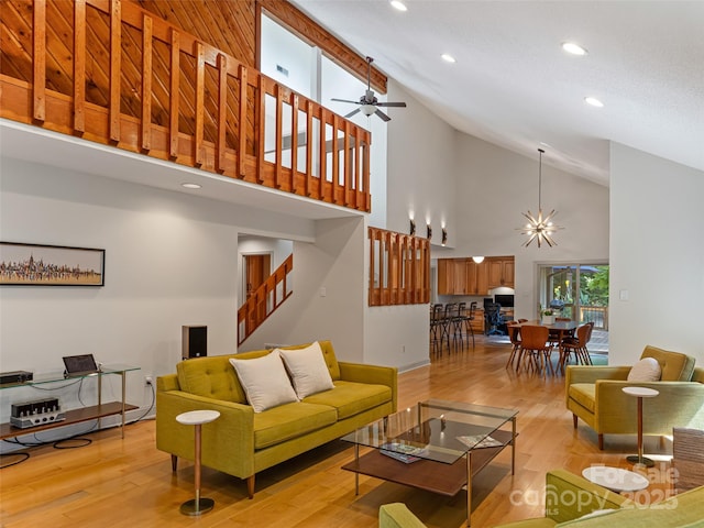 living room featuring light wood finished floors, stairs, and recessed lighting