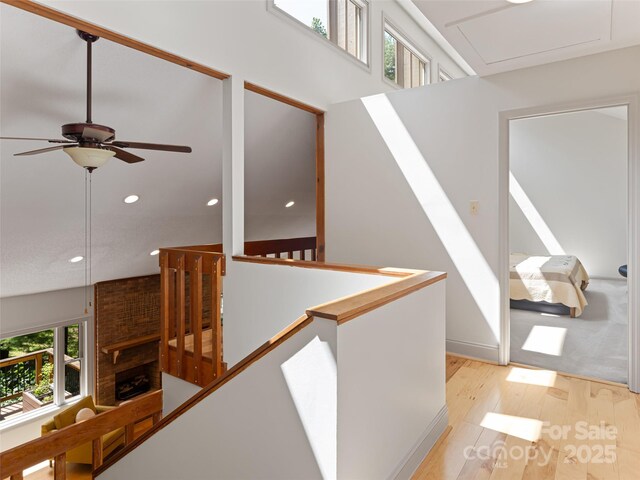 staircase with wood finished floors and recessed lighting