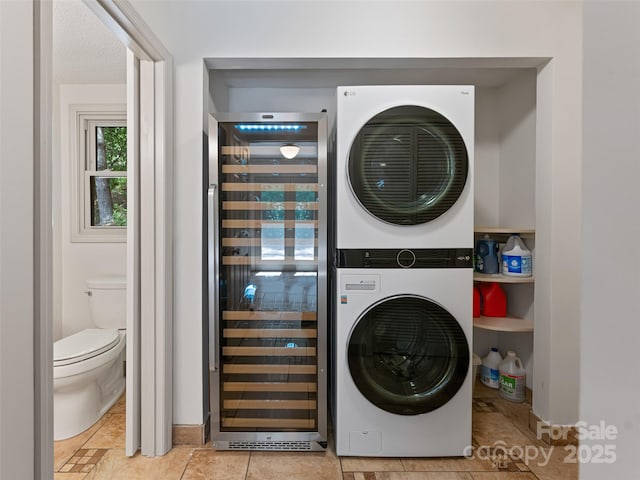 laundry room with laundry area, beverage cooler, a textured ceiling, and stacked washing maching and dryer