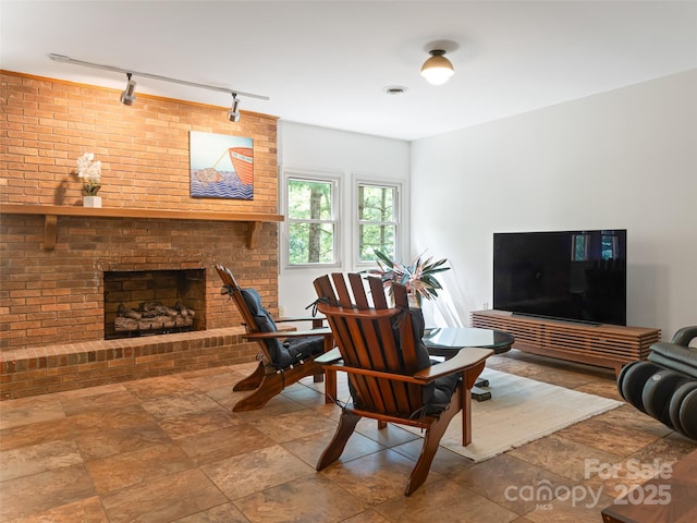 living room with a brick fireplace and visible vents