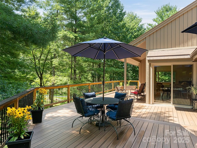 wooden deck featuring outdoor dining space