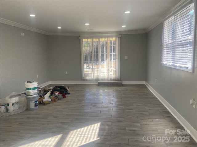 spare room with baseboards, recessed lighting, and crown molding